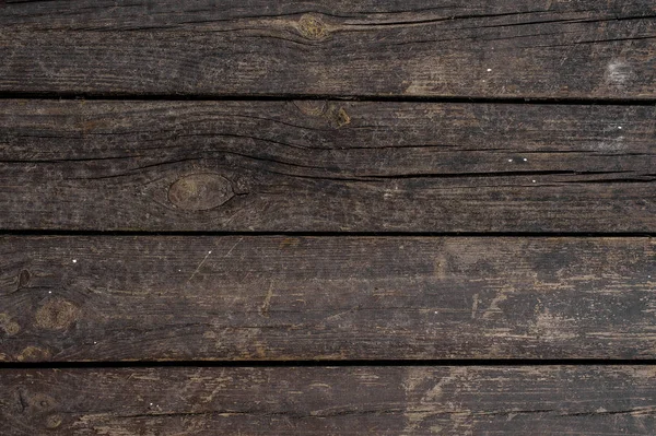 Nahaufnahme Textur Hintergrund der alten dunklen Holzbretter horizontal in einer Wand angeordnet — Stockfoto