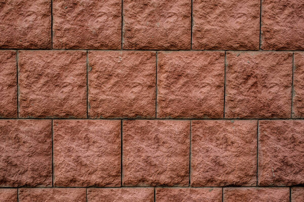 Macrophotography close up background texture of square red wall bricks