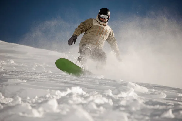 Muž sjíždí z kopce na snowboardu — Stock fotografie