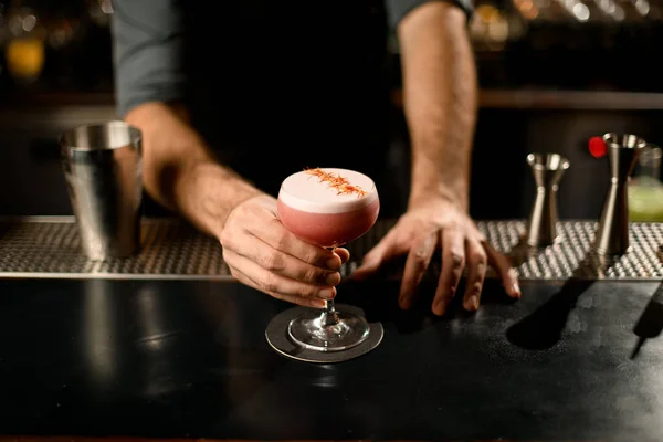 Barman segurando coquetel de álcool decorado em vidro pequeno — Fotografia de Stock