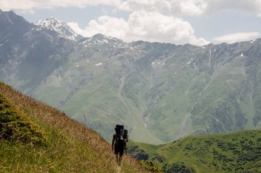 Prepared tourist walking in the high mountains
