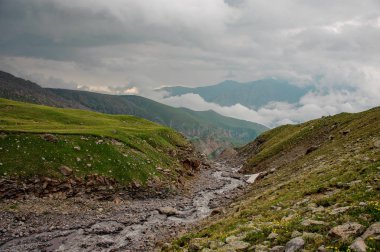 Landscape with riverbed among mountains and hills