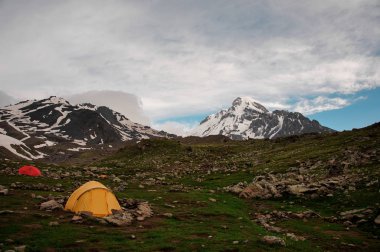 Small camp with tents among the hills