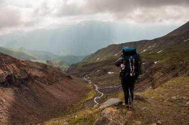 Prepared traveller rests on top of hill
