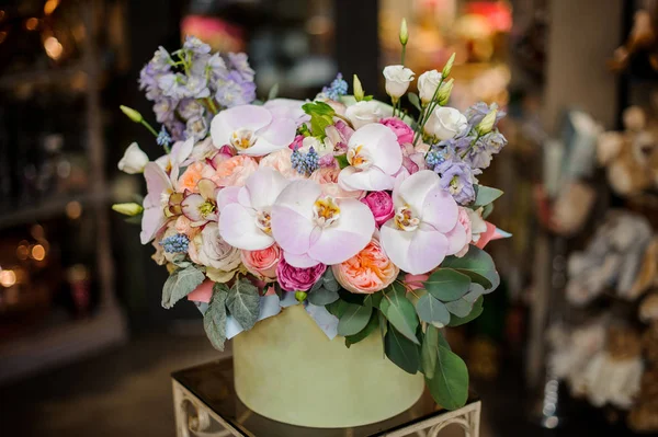 Green round box full of different tender color roses, orchids and bellflower decorated with green leaves — 스톡 사진