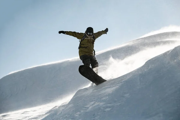 Freeride snowboarder jumping down the mountain snowcovered slope — 스톡 사진