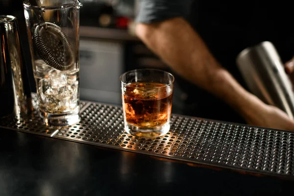 Close-up of whiskey in glass on bar counter — Stock Photo, Image