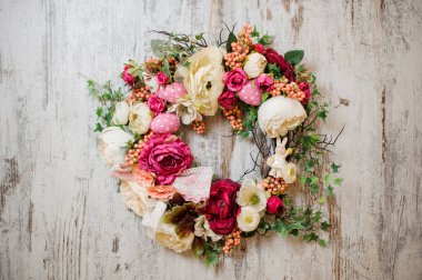 Holiday chaplet hangs on the white wall