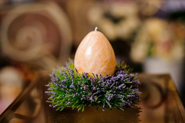 Candle in shape of easter egg on decorative table — 图库照片