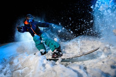 Woman freerider doing stunts on blue light background