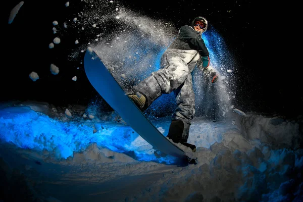 Male freerider doing stunts on blue light background — Stok fotoğraf