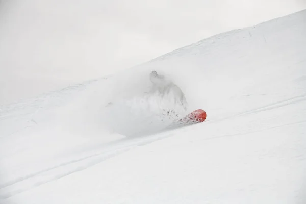 Professional man snowboarder descends from snowy mountain. — Stock Photo, Image