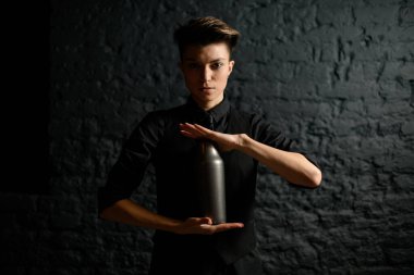 Kadın barmen ustalıkla elinde çeliği tutuyor.