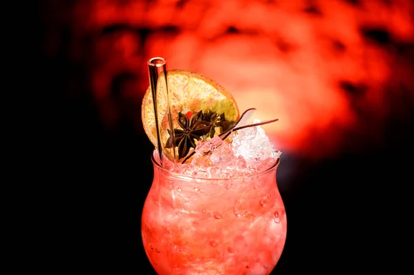 Close-up of glass with cold cocktail decorated with citrus and glass tube to drink. — Stock Photo, Image