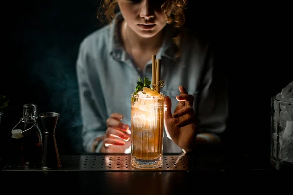 beautiful illuminated glass of ready-made cocktail stands on bar counter