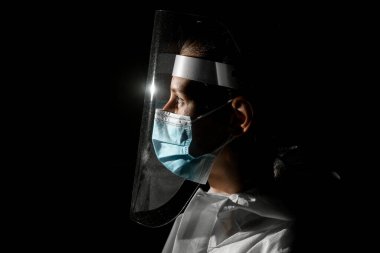 Tıbbi maskeli ve koruyucu ekranlı genç kız görüntüsü