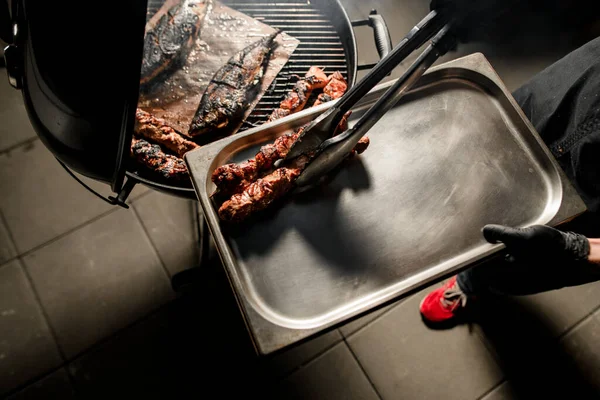 トップ表示男性シェフはグリルから金属トレイに牛肉肉の揚げ作品を置く方法 — ストック写真