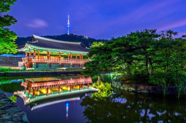 Namsangol Hannok Village and Seoul Tower Located on Namsan Mountain at night in Seoul,South Korea. clipart