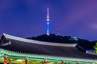 Namsangol Hannok Village and Seoul Tower Located on Namsan Mountain at night in Seoul,South Korea. clipart