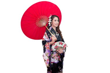 Beautiful young asian woman wearing traditional japanese kimono with red umbrella isolated on white background. clipart