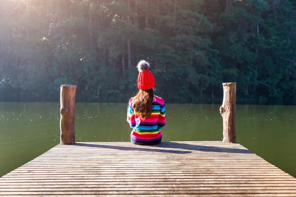 Young girl sitting on a pier. — Stock Photo, Image