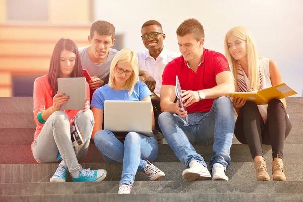 Aufnahme einer Gruppe lächelnder Universitätsstudenten, die auf irgendwas schauen. — Stockfoto