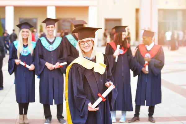 Hermosa chica de graduación sosteniendo su diploma con orgullo —  Fotos de Stock