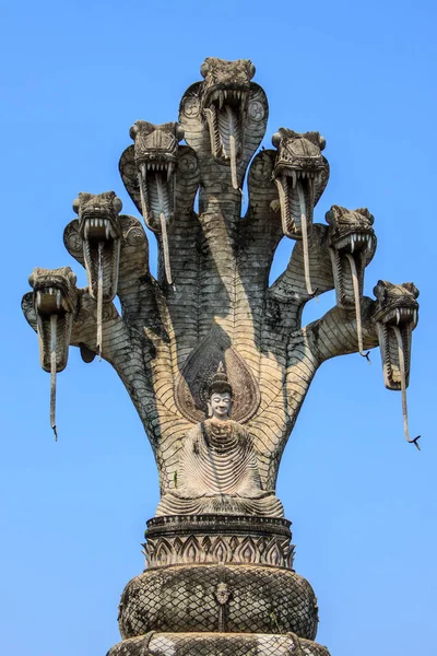 Gran imagen del Buda sentado bajo el dosel de las cabezas de la serpiente en la Sala Kaeo Ku o Wat Khaek en Nong Khai, Tailandia Fotos de stock