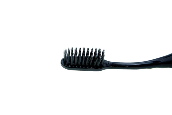 Μαύρο οδοντόβουρτσα σε λευκό φόντο — Φωτογραφία Αρχείου