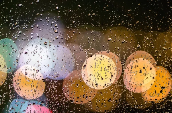 Night lights through the wet glass — Stock Photo, Image