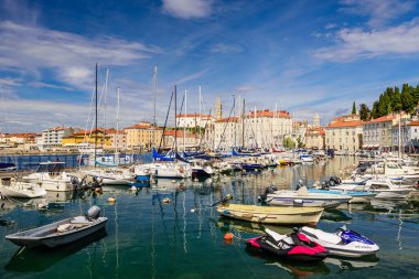 Piran, Slovenya - 19 Eylül 2016: Limanda güzel eski binaları ve tekneleri olan Piran şehri manzarası. Piran, Slovenya 'nın başlıca turistik merkezlerinden biri.
