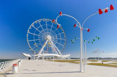 Bakü, Azerbaycan - 24 Şubat 2017: Bakü şehir merkezinde modern ışıklar ve arka planda dönme dolap ile gezinti.