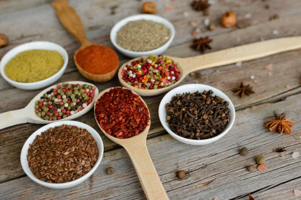 Various spices on wooden spoons — Stock Photo, Image