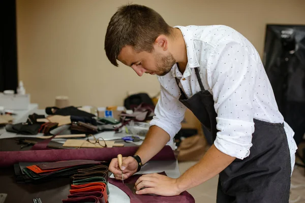 Leather handbag craftsman at work