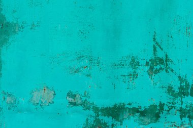 Çizik ve çatlaklarla dolu bir duvar parçası.