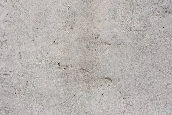 Çizik ve çatlaklarla dolu bir duvar parçası.