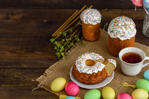 复活节蛋糕和五颜六色的鸡蛋在一张木桌上 它可以用作背景 — 图库照片