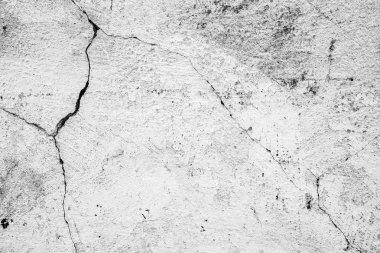 Çatlakları ve çizikleri olan beton bir duvarın dokusu arka plan olarak kullanılabilir.