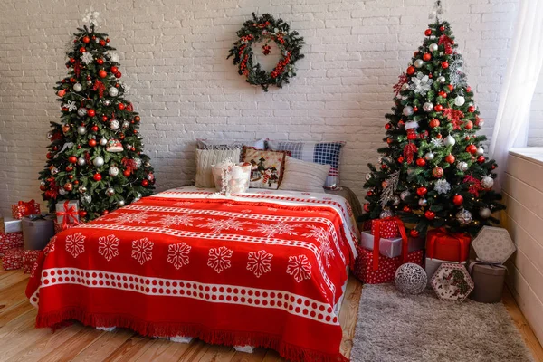 Beautiful holdiay decorated room with Christmas tree with presents under it