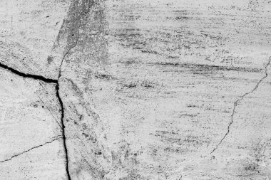 Çatlakları ve çizikleri olan beton bir duvarın dokusu arka plan olarak kullanılabilir.