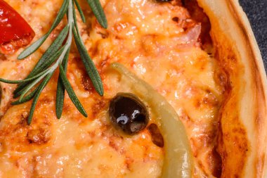 Koyu bir arka plana karşı lezzetli taze pizza. Pizza, yemek, sebze, mantar.