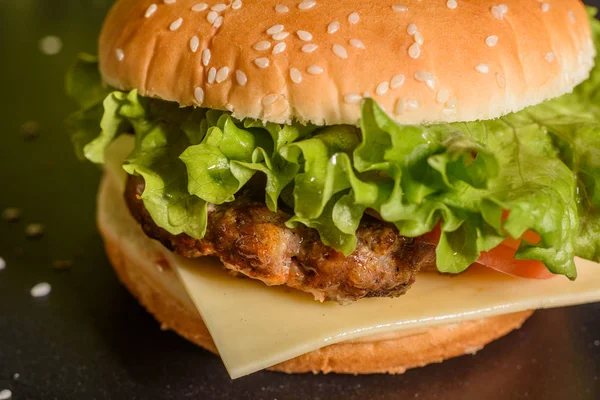 Hambúrguer caseiro grelhado saboroso com carne, tomate, queijo, pepino e alface — Fotografia de Stock