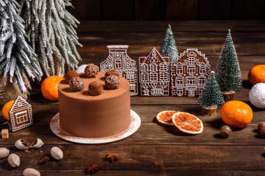 Christmas holiday table with delicious truffle cake and beautiful gingerbreads clipart