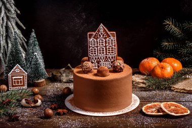 Christmas holiday table with delicious truffle cake and beautiful gingerbreads clipart