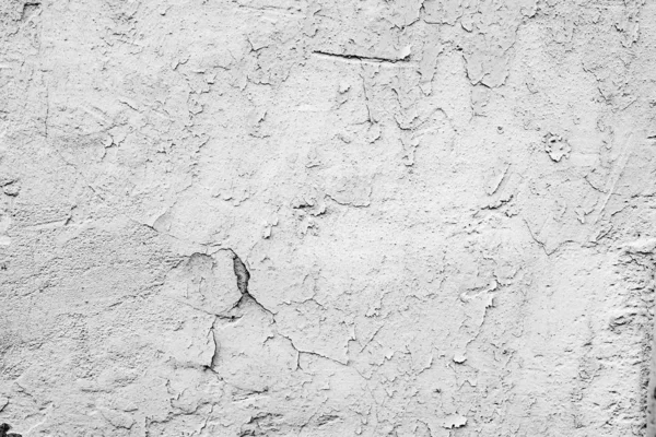 Texture d'un mur en béton avec des fissures et des rayures qui peuvent être utilisées comme fond — Photo