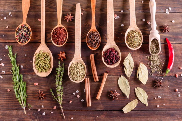A set of spices and herbs. Indian cuisine. Pepper, salt, paprika, basil and other on a dark background — Stock Photo, Image