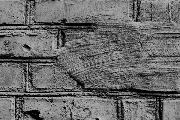 Texture d'un mur de briques avec des fissures et des rayures qui peuvent être utilisées comme fond — Photo