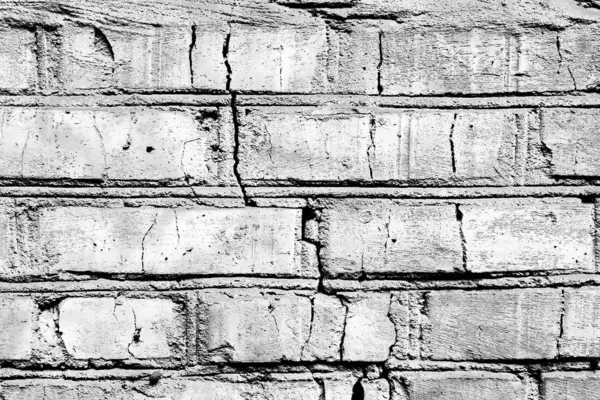 Υφή ενός τοίχου από τούβλα με ρωγμές και γρατσουνιές που μπορεί να χρησιμοποιηθεί ως φόντο — Φωτογραφία Αρχείου