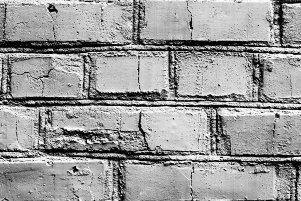Textura de una pared de ladrillo con grietas y arañazos que se puede utilizar como fondo — Foto de Stock