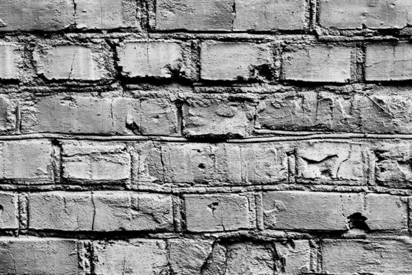 Текстура кирпичной стены с трещинами и царапинами, которые могут быть использованы в качестве фона — стоковое фото